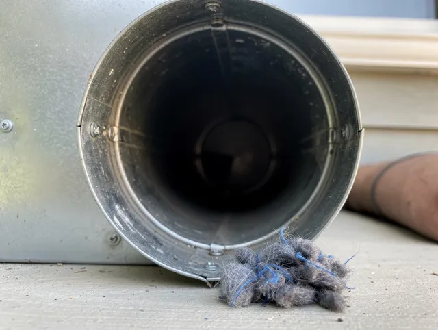 Temescal Valley Dryer Vent Cleaning technician using specialized equipment to clear severe dryer vent blockage in Temescal Valley